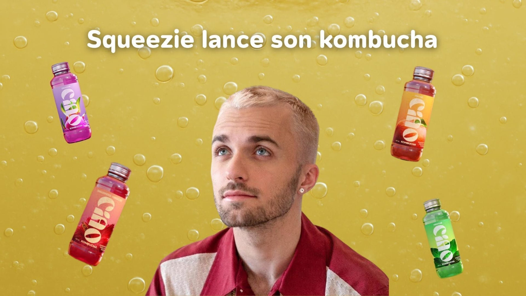 Squeezie au milieu de bouteilles en verre Ciao Kombucha.